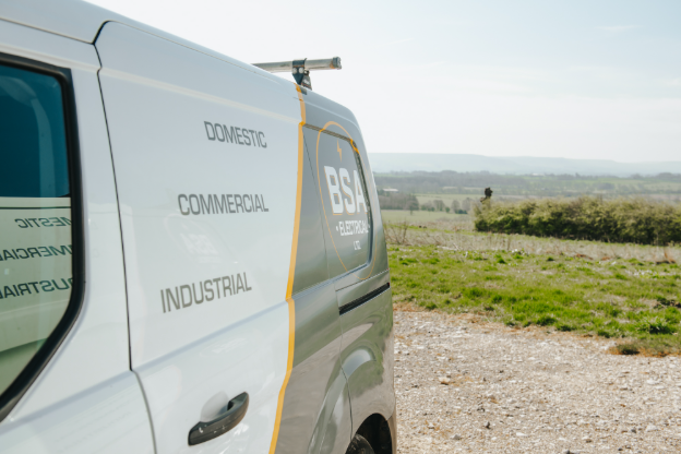 The side of an electrician's van that says Commercial, Domestic, Industrial.